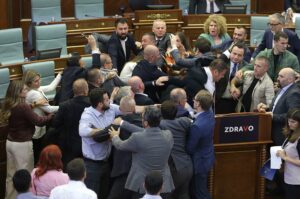 Ihmiset tappelevat parlamentin istuntosalissa.